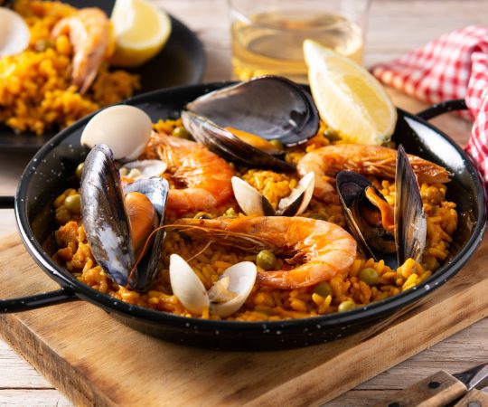 Traditional spanish seafood paella on wooden table